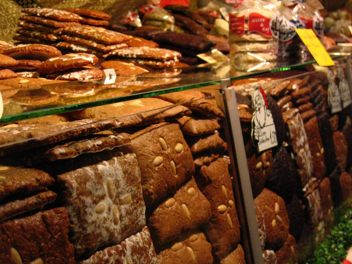 Stacks of chocolate-glazed and plain Nuremberg Lebkuchen on a market stall counter